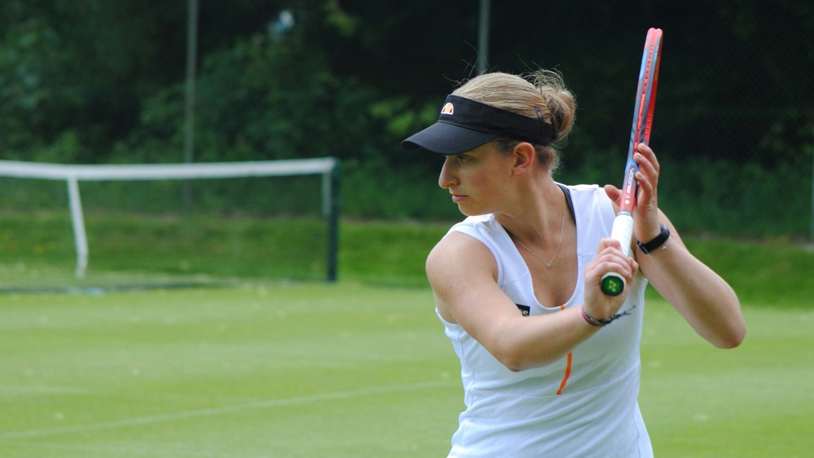 A woman holding a tennis racquet on a tennis court
